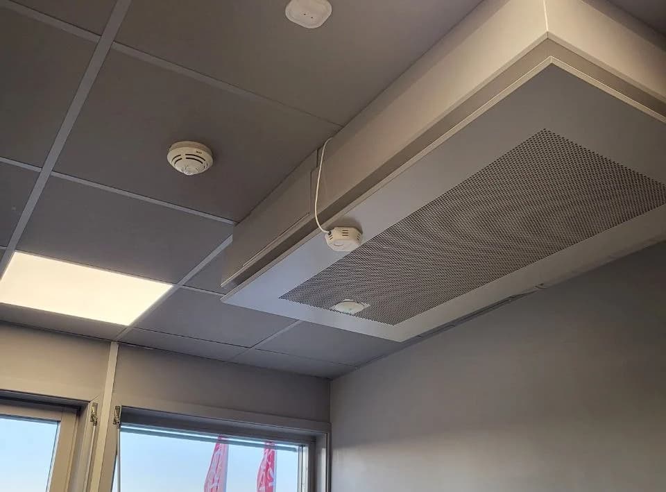 iThermal installed on a ceiling ventilation unit in an office